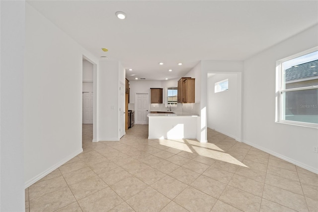 interior space featuring light tile patterned floors and kitchen peninsula