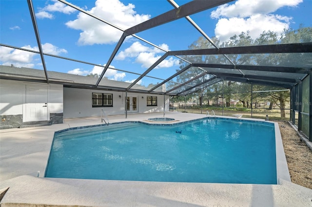 view of pool featuring an in ground hot tub, a lanai, and a patio area