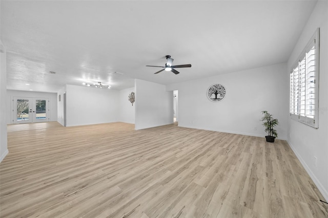 unfurnished living room featuring light hardwood / wood-style flooring, french doors, and ceiling fan