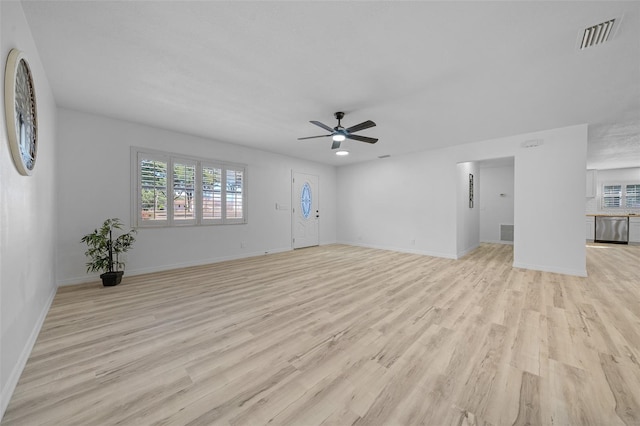 unfurnished living room featuring ceiling fan and light hardwood / wood-style flooring