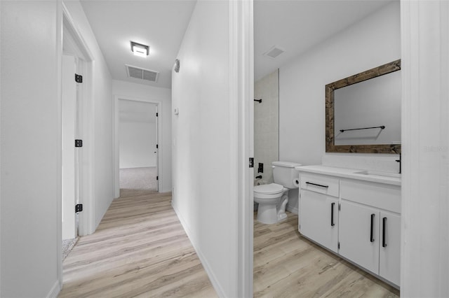 bathroom featuring vanity, hardwood / wood-style floors, and toilet