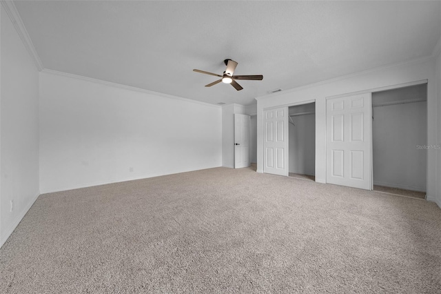 unfurnished bedroom with crown molding, ceiling fan, and carpet