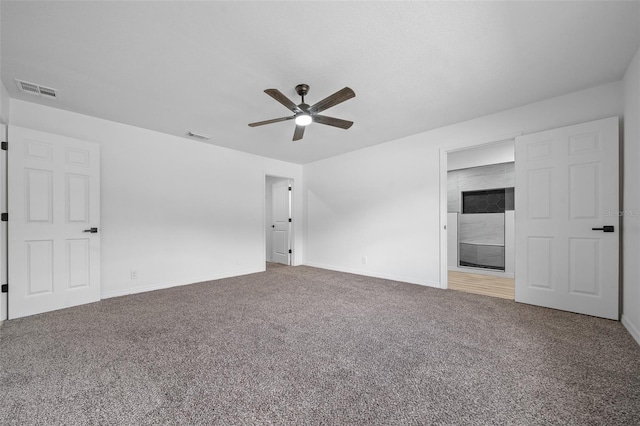 carpeted spare room with ceiling fan