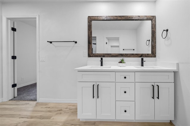 bathroom with vanity and hardwood / wood-style floors