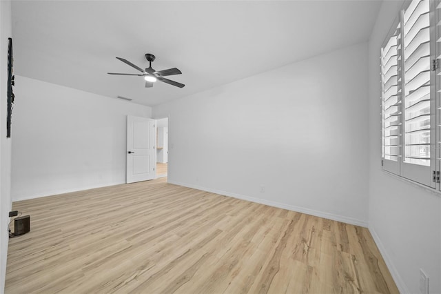 empty room featuring ceiling fan and light hardwood / wood-style flooring