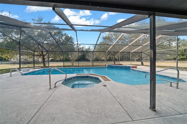 view of pool with a lanai, a patio, and an in ground hot tub