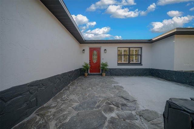 doorway to property with a patio