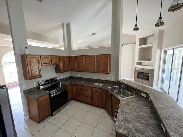 kitchen with sink, built in features, stainless steel range with electric stovetop, plenty of natural light, and decorative light fixtures