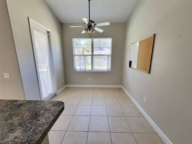 tiled dining area with ceiling fan