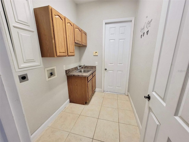 laundry room featuring sink, electric dryer hookup, hookup for a washing machine, cabinets, and light tile patterned flooring