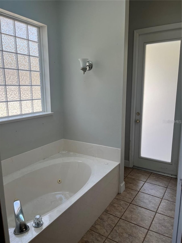 bathroom featuring a washtub and tile patterned flooring