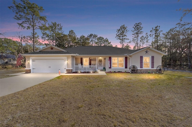 single story home featuring a yard, a garage, and a porch