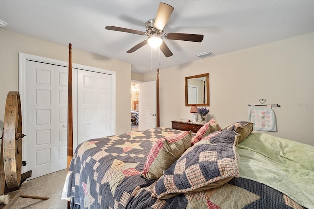 carpeted bedroom featuring ceiling fan and a closet