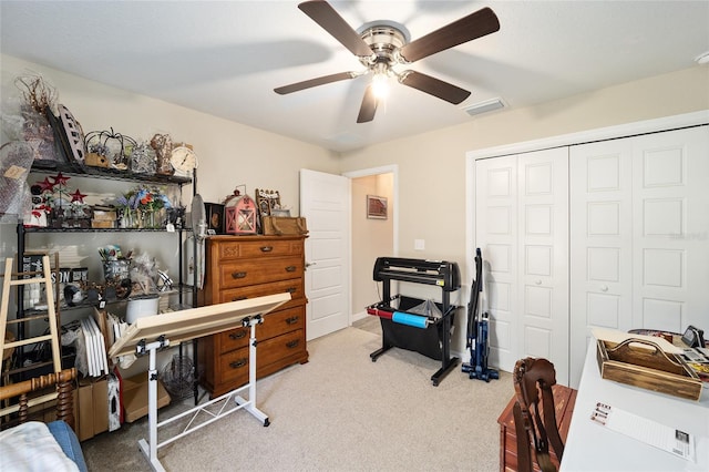 carpeted office featuring ceiling fan