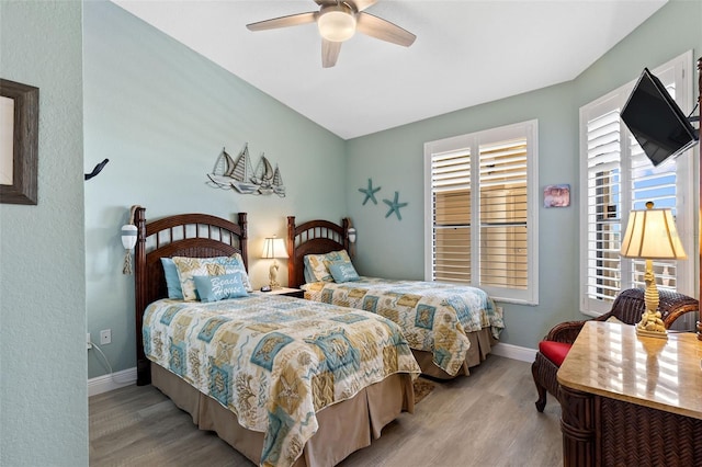 bedroom with ceiling fan and light hardwood / wood-style flooring