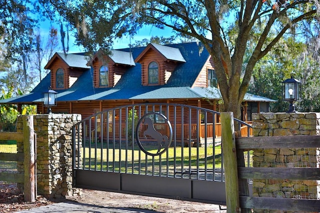 view of gate with a lawn