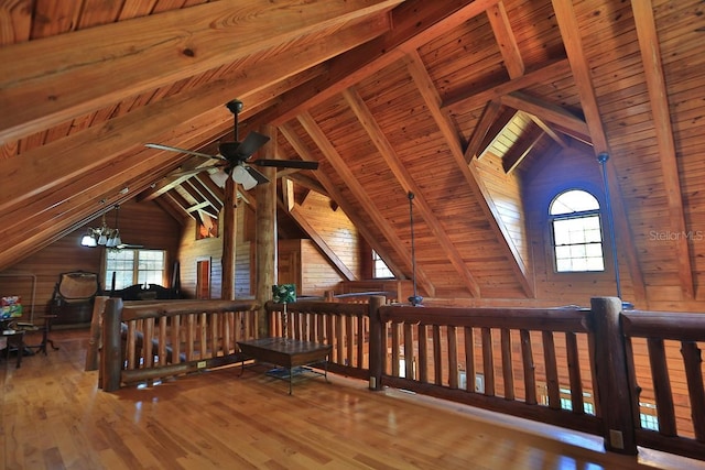 interior space with hardwood / wood-style floors, wooden walls, vaulted ceiling with beams, and wooden ceiling