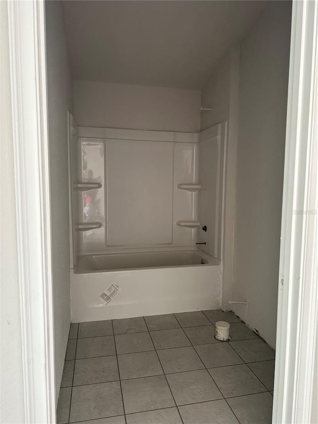 bathroom with tile patterned floors and shower / bath combination