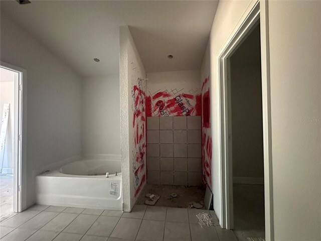 full bath with a shower stall, a bath, and tile patterned floors