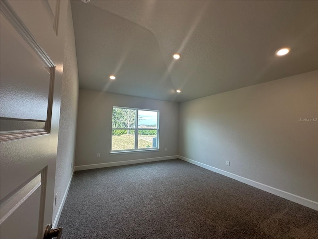 unfurnished room featuring baseboards, dark carpet, and recessed lighting