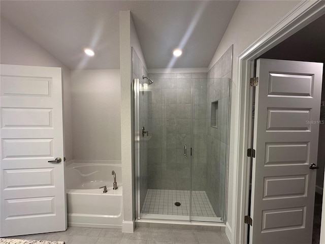 full bath featuring lofted ceiling, a shower stall, and a bath