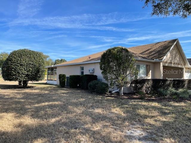 view of property exterior featuring a lawn