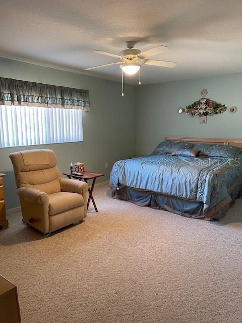 bedroom with a textured ceiling, carpet floors, and ceiling fan