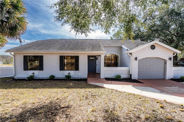 single story home featuring a garage and a front lawn