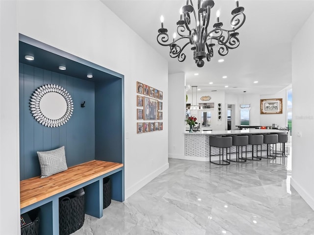 mudroom with a chandelier