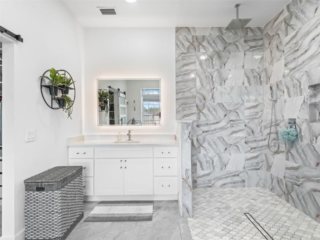 bathroom featuring vanity and a tile shower