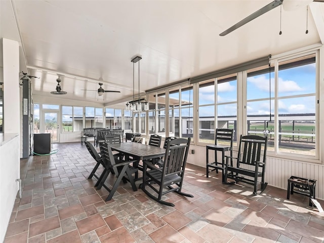 sunroom / solarium featuring ceiling fan