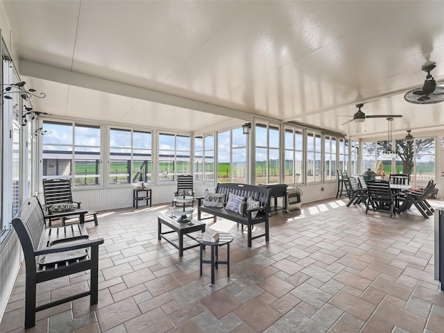 sunroom / solarium with a healthy amount of sunlight and ceiling fan