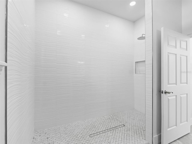 bathroom with a tile shower