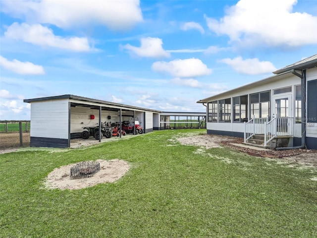 view of yard with a sunroom and a carport