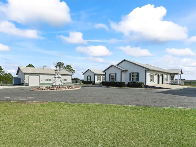 view of front of house featuring a garage and a front lawn