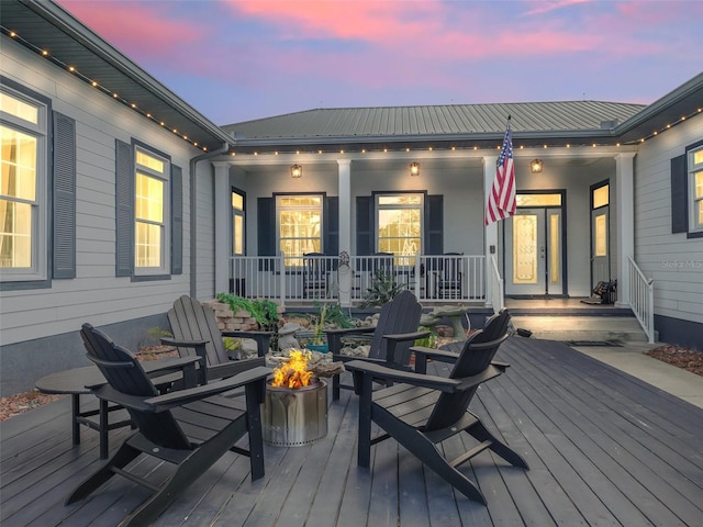 wooden terrace with a fire pit