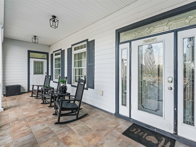 view of exterior entry featuring a porch
