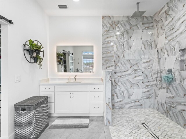 full bath with marble finish floor, visible vents, a walk in shower, and vanity