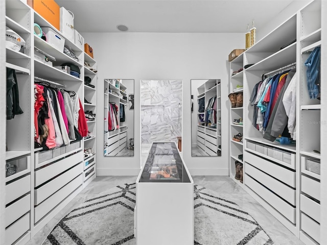 spacious closet with marble finish floor