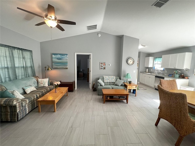 living room featuring lofted ceiling, sink, and ceiling fan