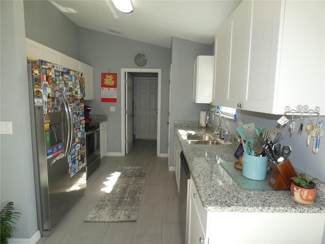 kitchen with white cabinetry, sink, and stainless steel appliances