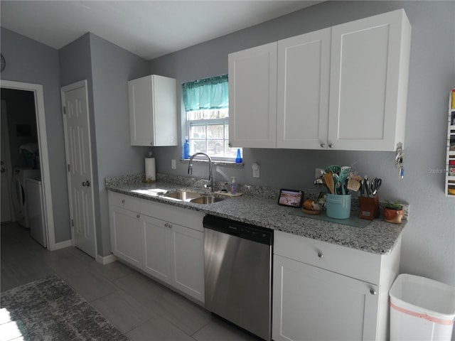 kitchen with white cabinetry, dishwasher, light stone countertops, and sink