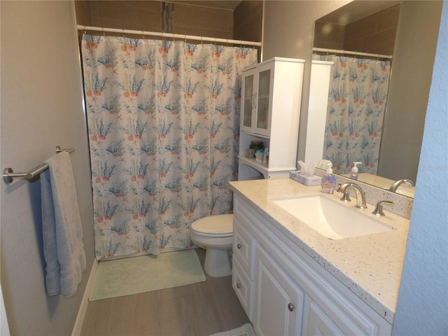 bathroom featuring vanity, hardwood / wood-style flooring, curtained shower, and toilet