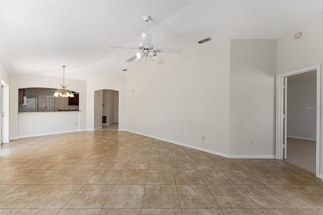 unfurnished living room featuring baseboards, a textured ceiling, visible vents, arched walkways, and ceiling fan with notable chandelier