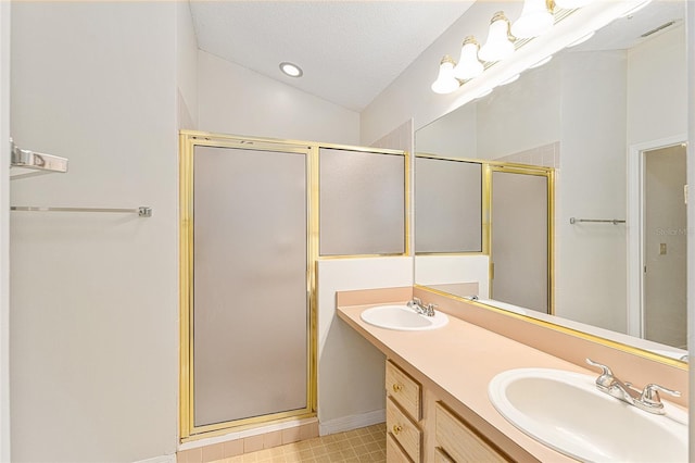 full bathroom with a stall shower, double vanity, a sink, and lofted ceiling