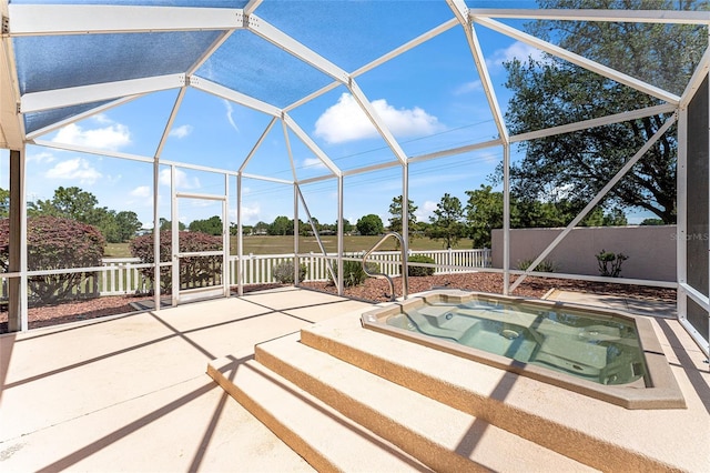 view of pool featuring a patio area, an in ground hot tub, a lanai, and fence