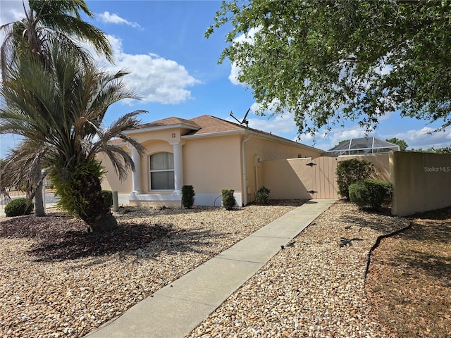 view of home's exterior with a gate and stucco siding