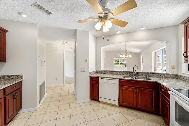 kitchen featuring visible vents, arched walkways, a sink, white appliances, and reddish brown cabinets