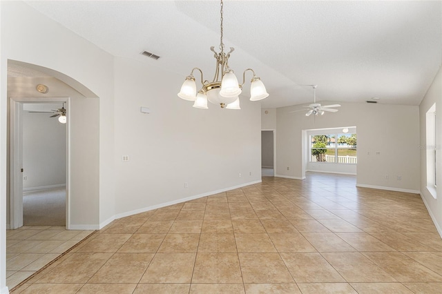 empty room with baseboards, light tile patterned flooring, lofted ceiling, arched walkways, and ceiling fan with notable chandelier