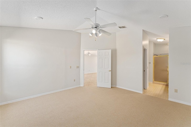 unfurnished bedroom featuring baseboards, visible vents, light colored carpet, and a textured ceiling